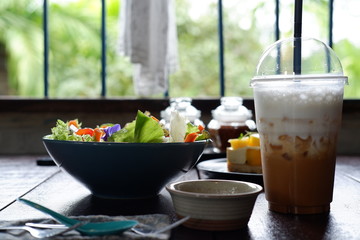 fruit salad and vegetable salad on wood table