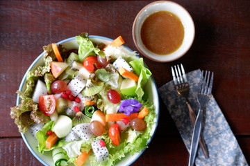 fruit salad and vegetable salad on wood table
