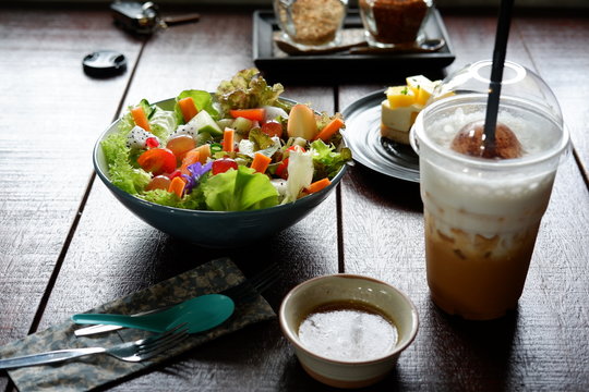 fruit salad and vegetable salad on wood table