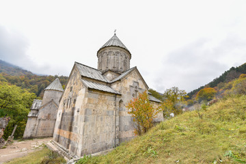 Beautiful Armenian monastery Haghartsin in the autumn forest.