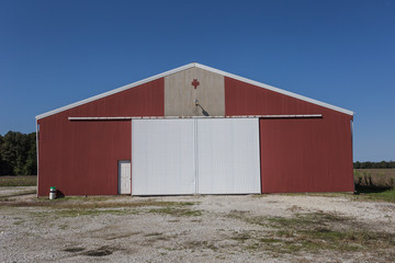 Large red barn with white doors
