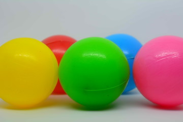 Some colorful plastic toy balls on white background