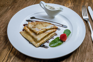 Pancakes with berries and sour cream