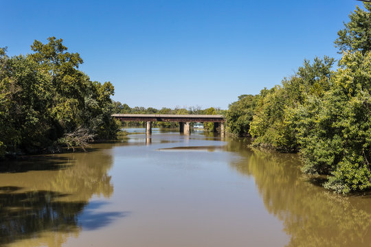 Muddy River Flowing Under Old Bridge