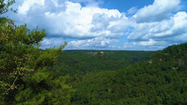 Flying North from Princess Arch toward a rock formation over a beautiful valley of trees.