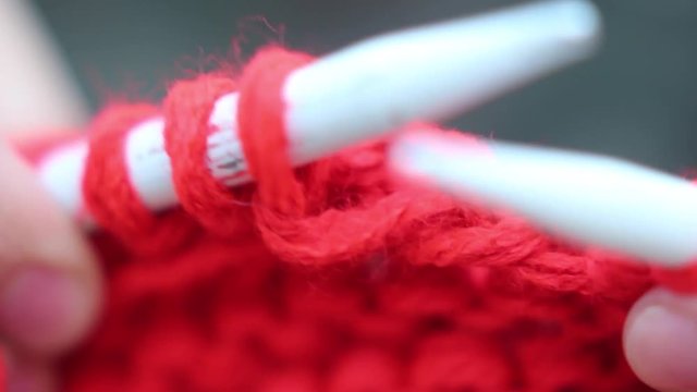 Woman knitting, short plane. Shallow dof.