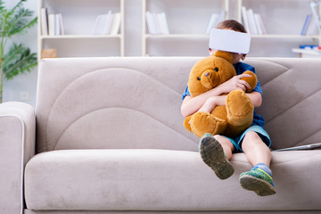 Young little boy with VR virtual reality glasses