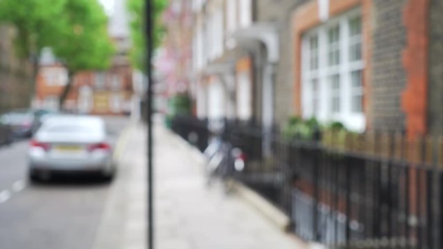 Defocused shot of row of pretty townhouses on quiet street in London, England