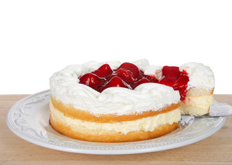 Obraz na płótnie Canvas Strawberry short cake with cream filling on white plate, whipped cream and strawberries on top. Slice being pulled out of cake. On wood table isolated white background.
