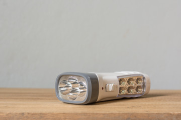 Close up LED flashlight on wood background, Multi function LED flashlight for home,Home accessories,