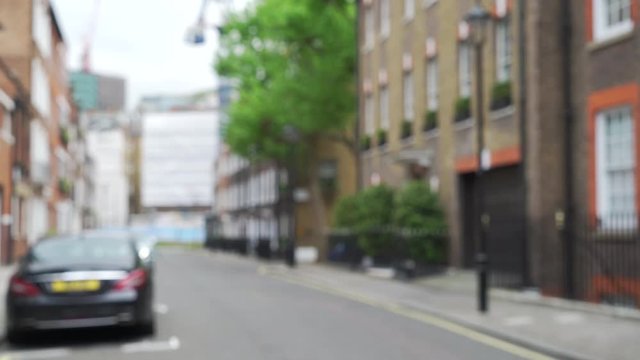 Blurred shot of residential street in London with cute apartments or flats 