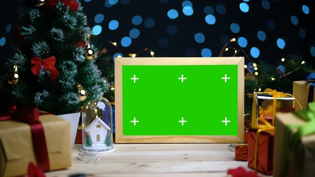 Dolly Shot of Green Screen Frame Between Christmas Decoration. With Tracking Marks. 4K