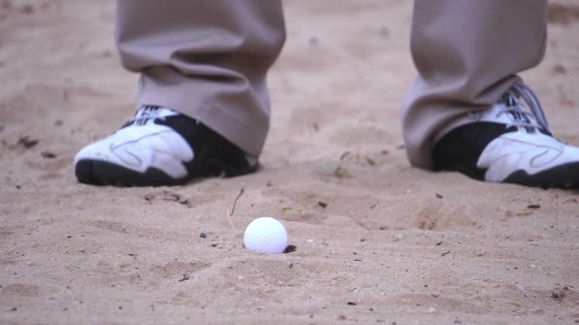 Golfers are hitting the golf ball on the bunker footage slow motion