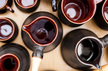 Clay jezve with wooden handle and coffee cups