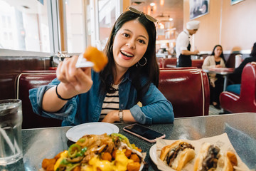 a beautiful traveler trying American food