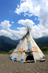  wigwam in the mountains against the blue sky with clouds © Татьяна Сивицкая