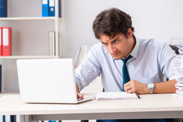 Overloaded busy employee with too much work and paperwork