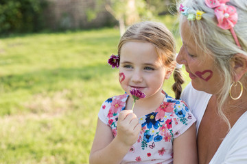 Grandmother and granddaughter playing outdoors