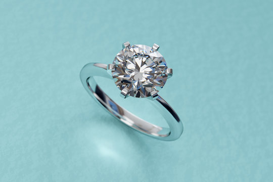 White gold solitaire diamond engagement ring on tiffany blue background. 3D rendering
