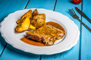 Grilled pork steak and fried potatoes
