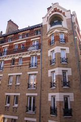 Roofs, facades, balconies and chimneys of buildings in Paris