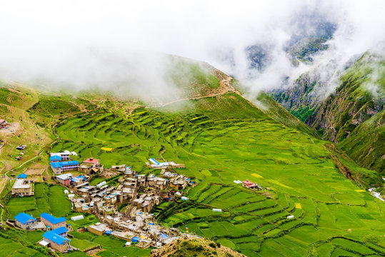 Green terraced fields and traditional architecture in the ancient Tibetan Nar village, Annapurna Conservation Area, Nepal
