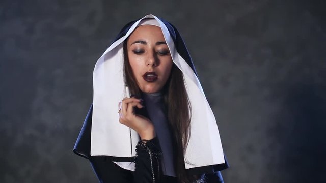 Sexy nun in the church. Theme of sin