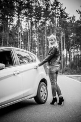 European mature elegant woman and car, lady driving automobile, outdoors portrait. Middle age woman driving on road, trip on beautiful autumn day. Concept of women and auto  