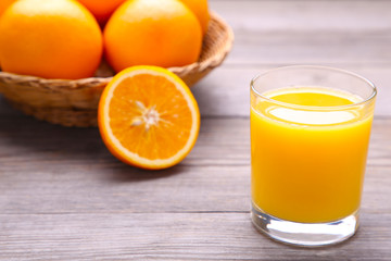 Glass of orange juice on wooden table