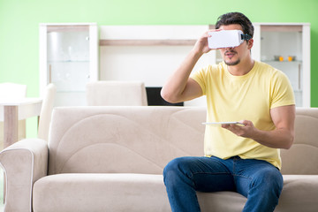 Fototapeta premium Young man with virtual reality goggles