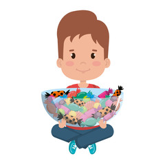 little boy lifting sweet candies set in bowl