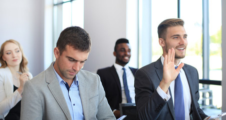 Group of businessmen sitting in conference to speech while having business meeting.