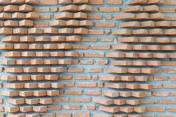 abstract orange brick wall on gray cement background texture.