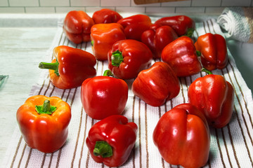 Red sweet peppers at the kitchen towel. Fresh vegetables.Selective focus.