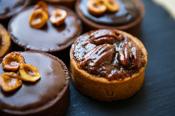 Delicious chocolate cakes with nuts on plate in cafe