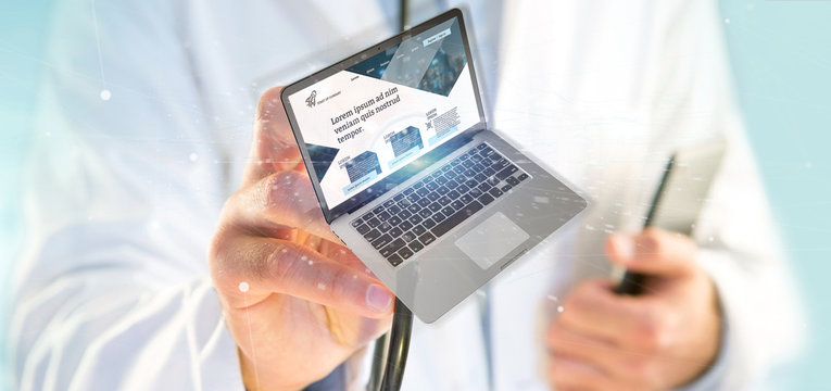Doctor holding a Laptop with business website template on the screen isolated on a background