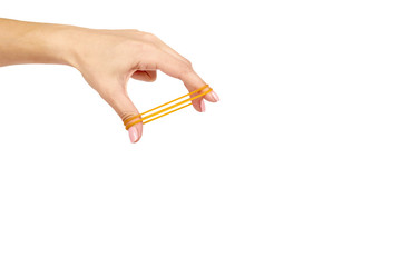 Yellow rubber bands close up with hand isolated on white background, copy space template.