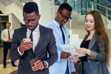 Portrait of ambitious business team diverse ethnicity multinational people in stylish suit getting communicating together in lobby of modern the office .