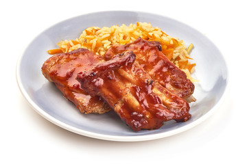 Delicious spicy marinated ribs in a bbq or tomato sauce with rice, isolated on a white background