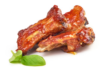 Chinese spicy marinated ribs in a bbq or tomato sauce with basil leaves, isolated on a white background. Close-up
