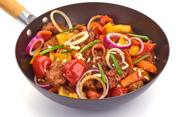 Grilled Pork with fried vegetables in a frying pan, Chinese recipes WOK. Isolated on white background