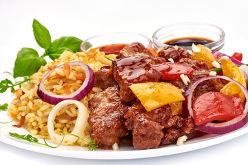 Roast Sweet and Sour Pork with vegetables with rice, Chinese recipes WOK. Isolated on white background. Close-up.