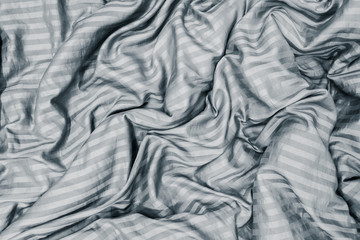 blanket wrinkled on the bed in bedroom.