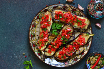 Spicy baked eggplant grilled with tomatoes and peppers.