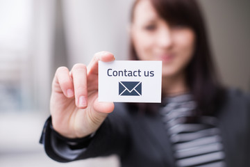 Hand holding business card with the message contact icons