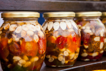 Healthy combination of natural honey with various nuts and dried fruits in jars