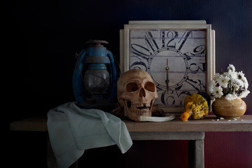 Skull, death and time is true story of nature human  all on the plank dim light