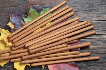 Rye bread sticks on autumn leaves