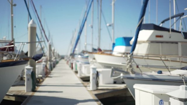 Leading lines down a long dock of parked boats at the marina 
