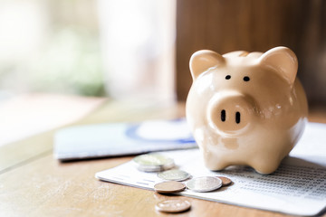 Fototapeta Piggy bank with coins and saving book bank obraz